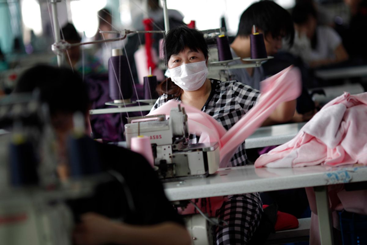 An employee works at the Yiwu Lianfa clothing factory in Yiwu, Zhejiang province, June 8, 2011      (Carlos Barria / Reuters)