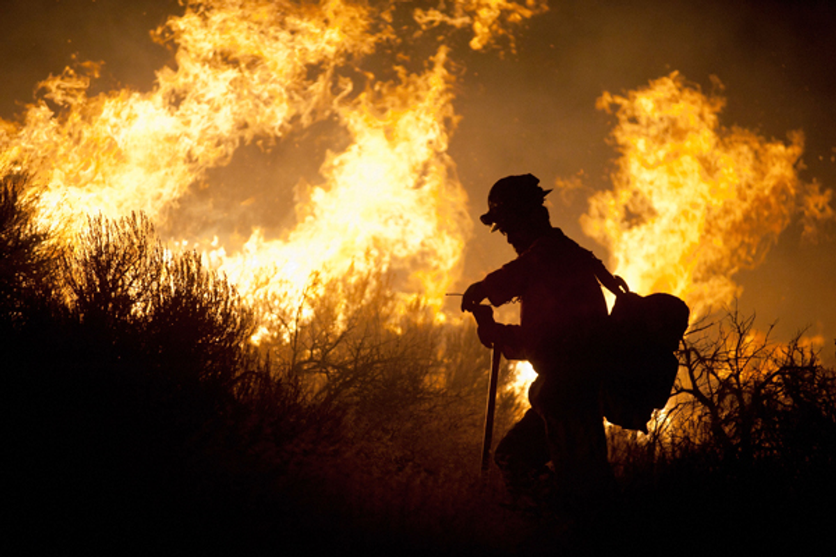 A crew member from the Nevada Department of Forestry works to control the Washoe Drive fire in Washoe City, Nev. on January 19, 2012     (Reuters/James Glover II)