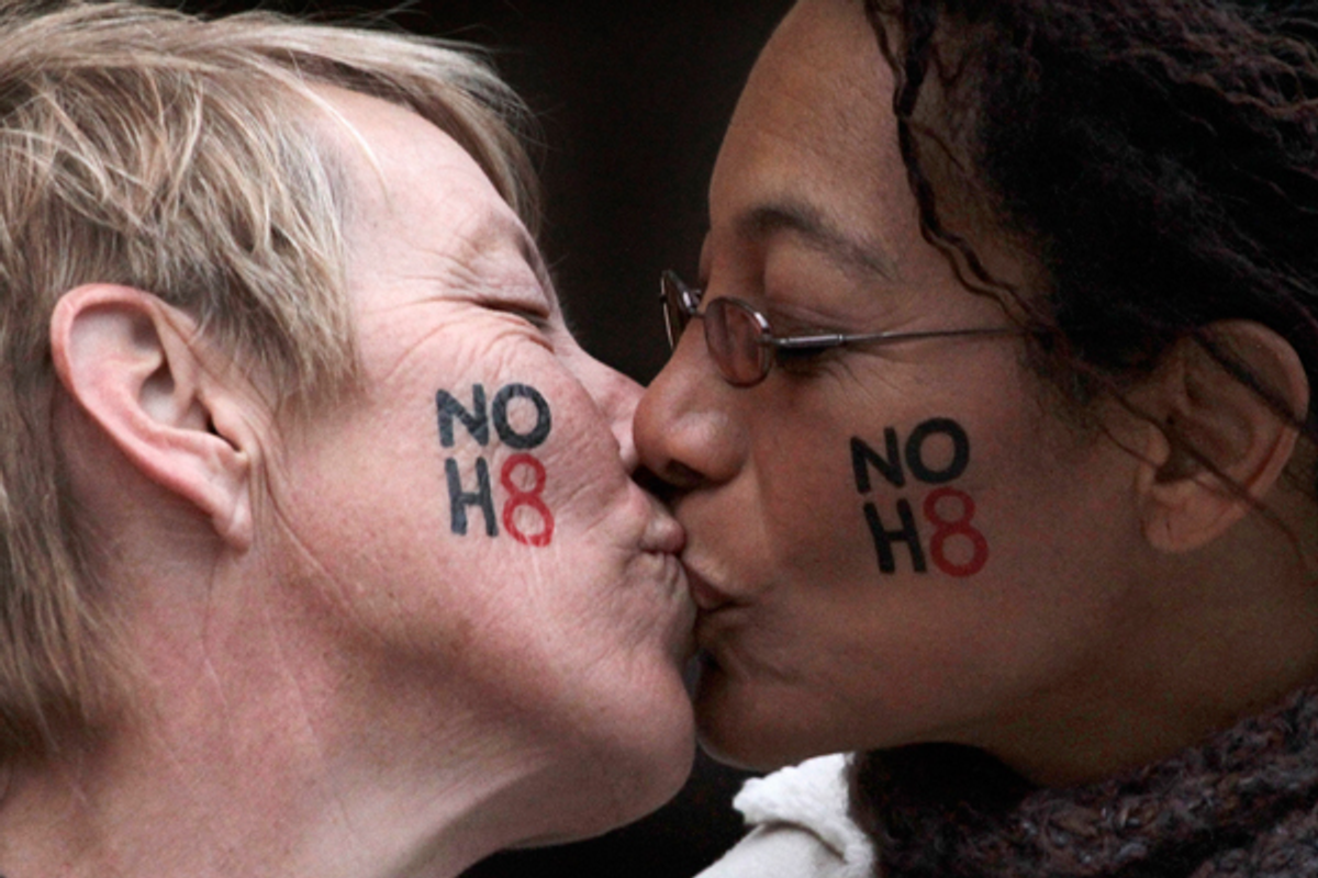 Lori Campbell (L) and Maja Roble, who are engaged, kiss at a celebration rally for Tuesday's ruling on Proposition 8 in West Hollywood, California February 7, 2012  (Reuters/Jonathan Alcorn)