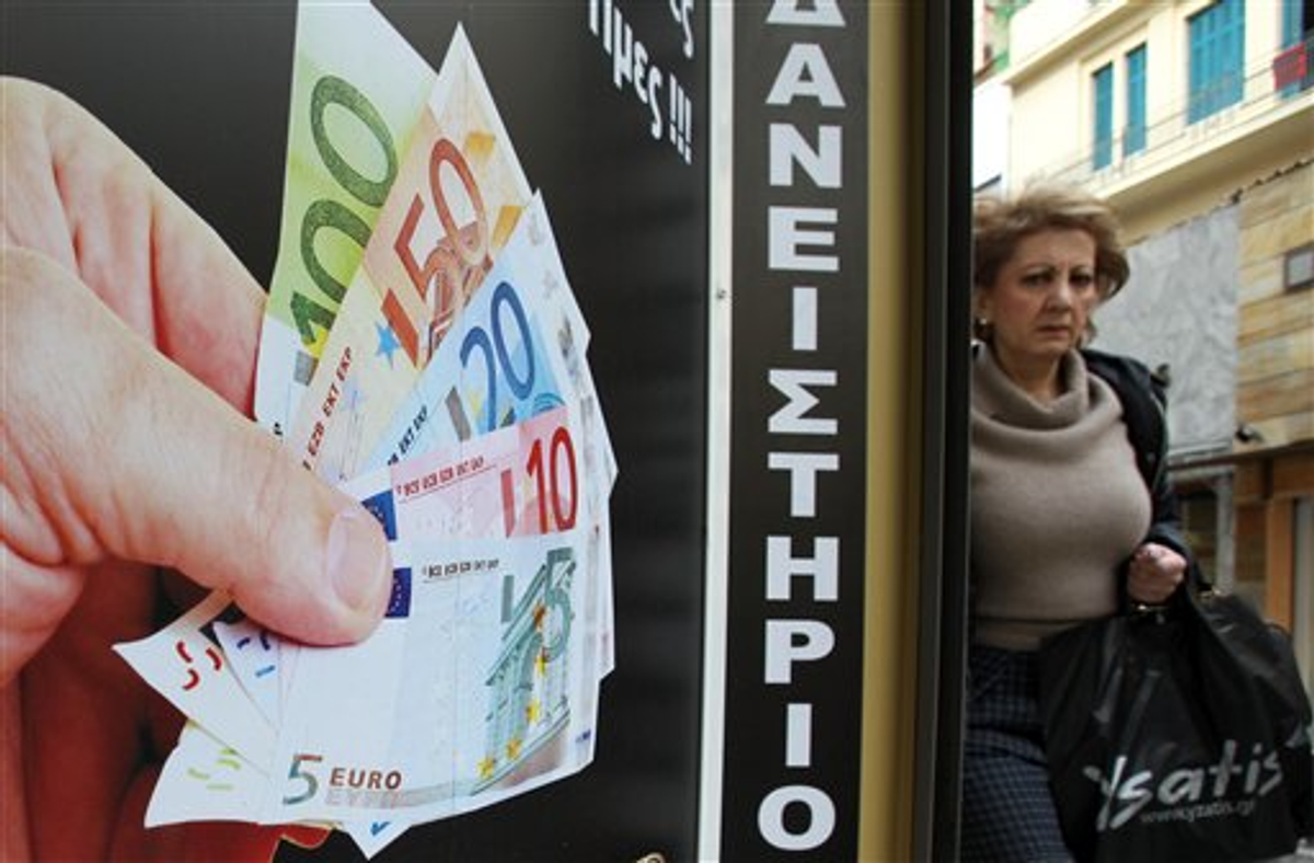  A pedestrian passes outside a pawnshop in Athens, Tuesday, Feb. 21, 2012  (AP Photo/Thanassis Stavrakis)
