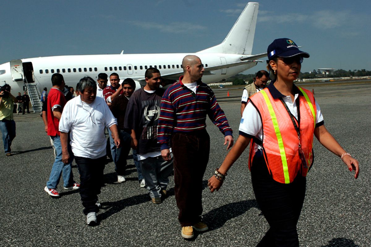 Guatemalans deported from the United States are escorted by an immigration official upon their arrival at La Aurora International Airport in Guatemala City.       (AP/Moises Castillo)