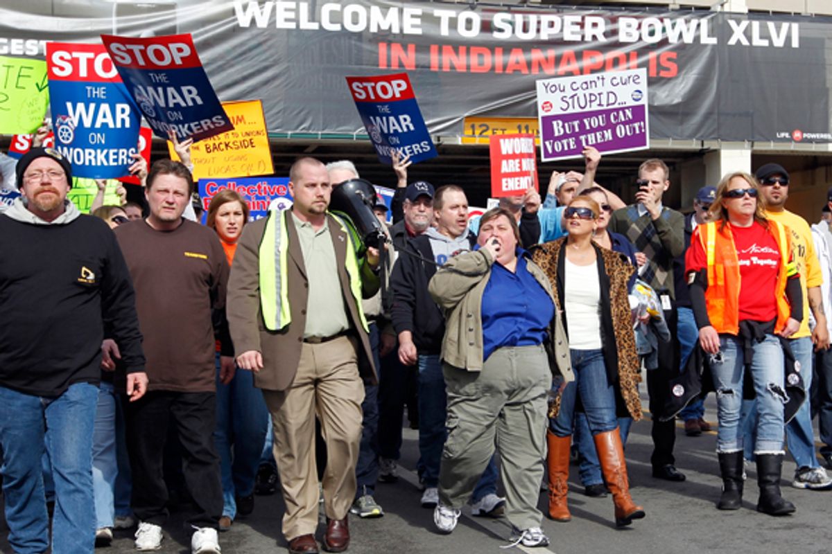 Muted union protestors in the Super Bowl Village on Sunday.         (AP/Michael Conroy)
