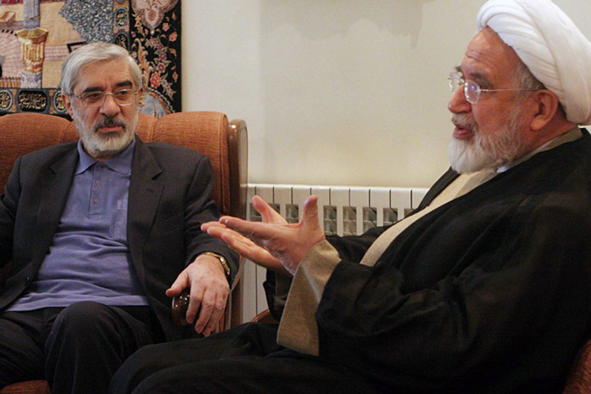 The now-confined leaders of Iranian opposition, Mahdi Karroubi, right, and Mir Hossein Mousavi, talk in freer days in Tehran.      (AP)