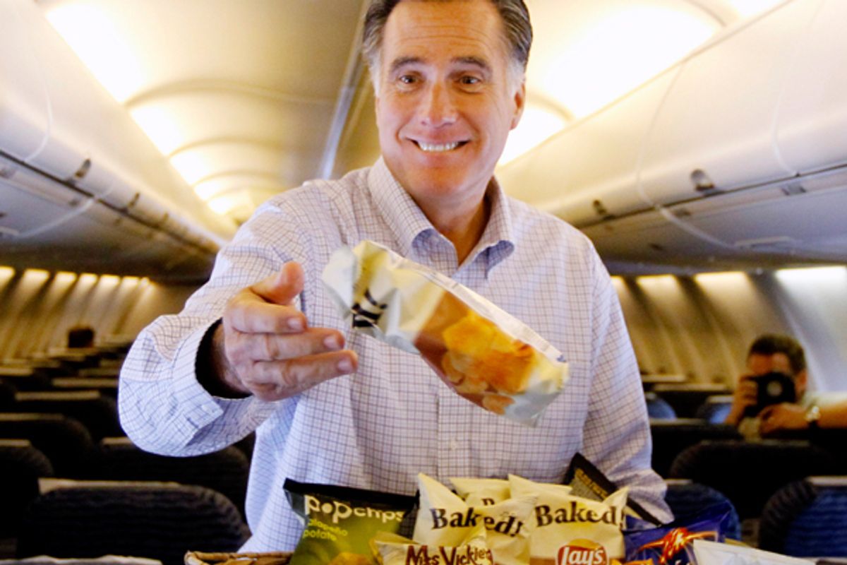 Mitt Romney throws bags of chips at traveling reporters on his campaign charter plane.       (AP/Charles Dharapak)