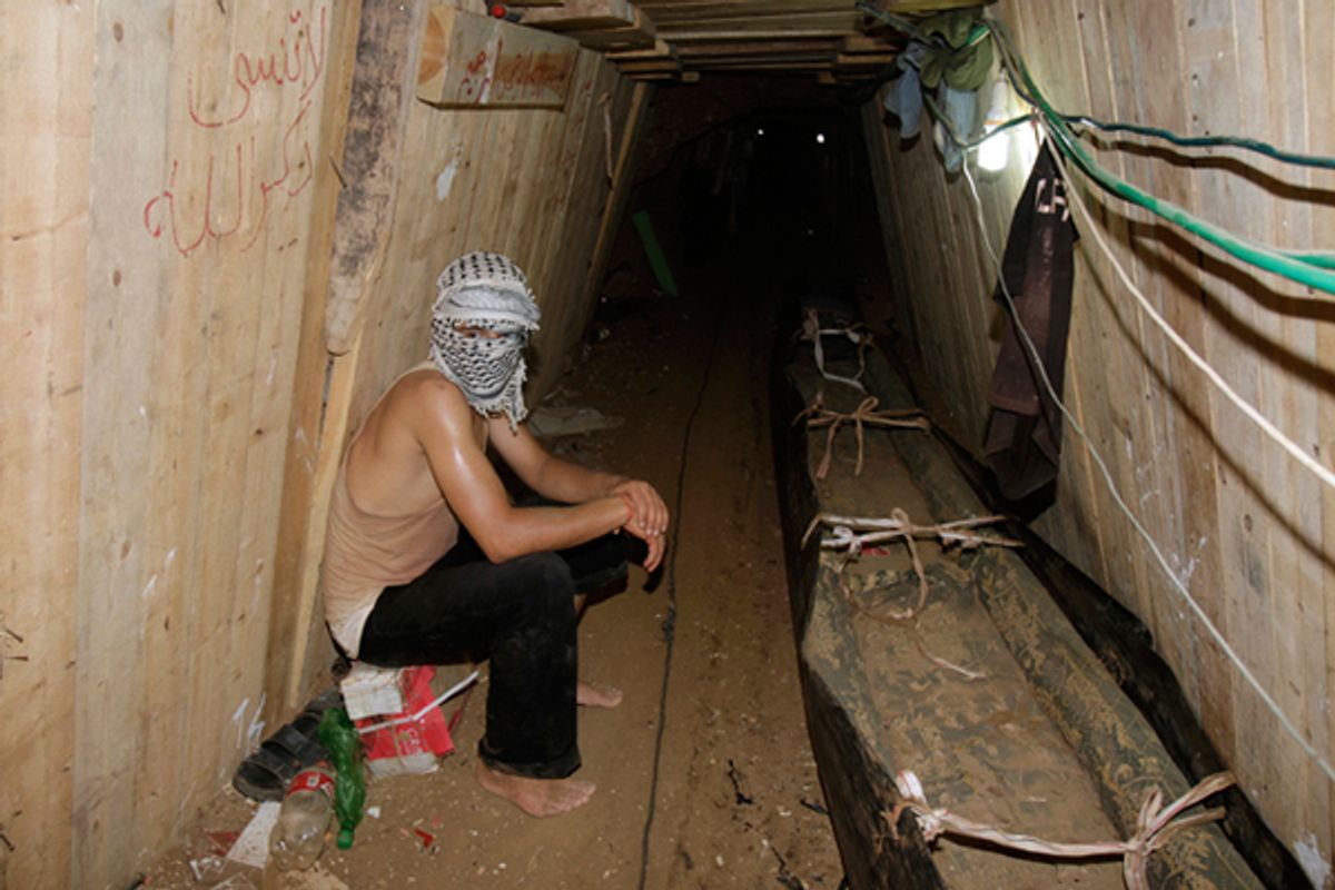 A Palestinian sits in a smuggling tunnel beneath the Egyptian-Gaza border in Rafah.  (Reuters//Ibraheem Abu Mustafa)