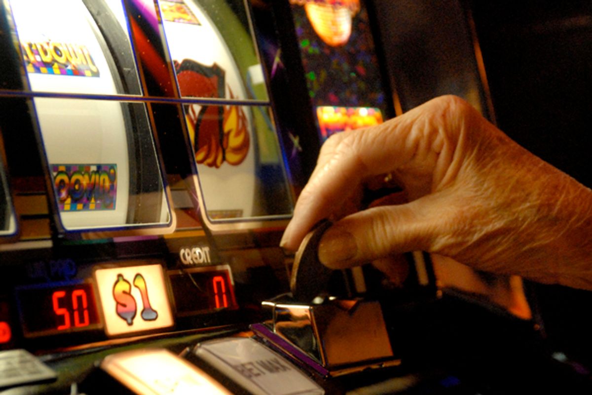 A player puts a dollar coin in an Atlantic City slot machine        (AP)