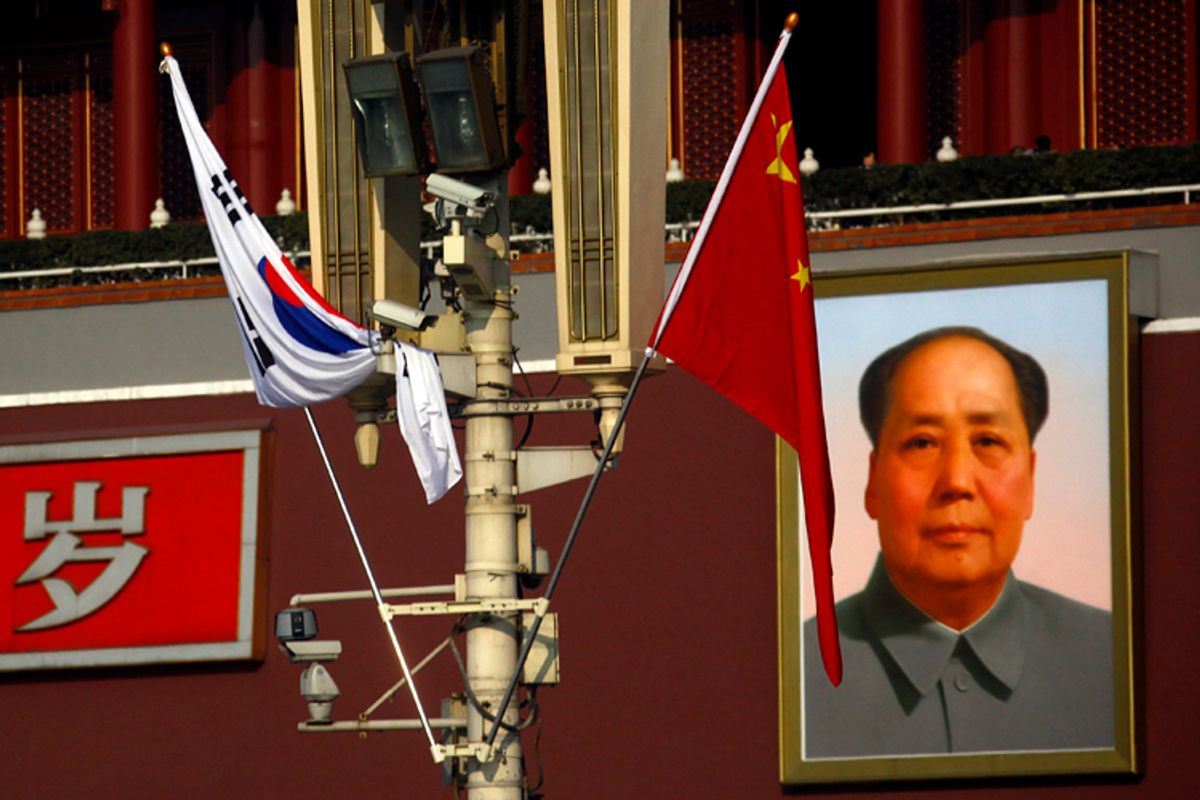 Security cameras on a pole in front of the giant portrait of former Chinese Chairman Mao Zedong at Beijing's Tiananmen Square Jan. 9, 2012.               (David Gray / Reuters)