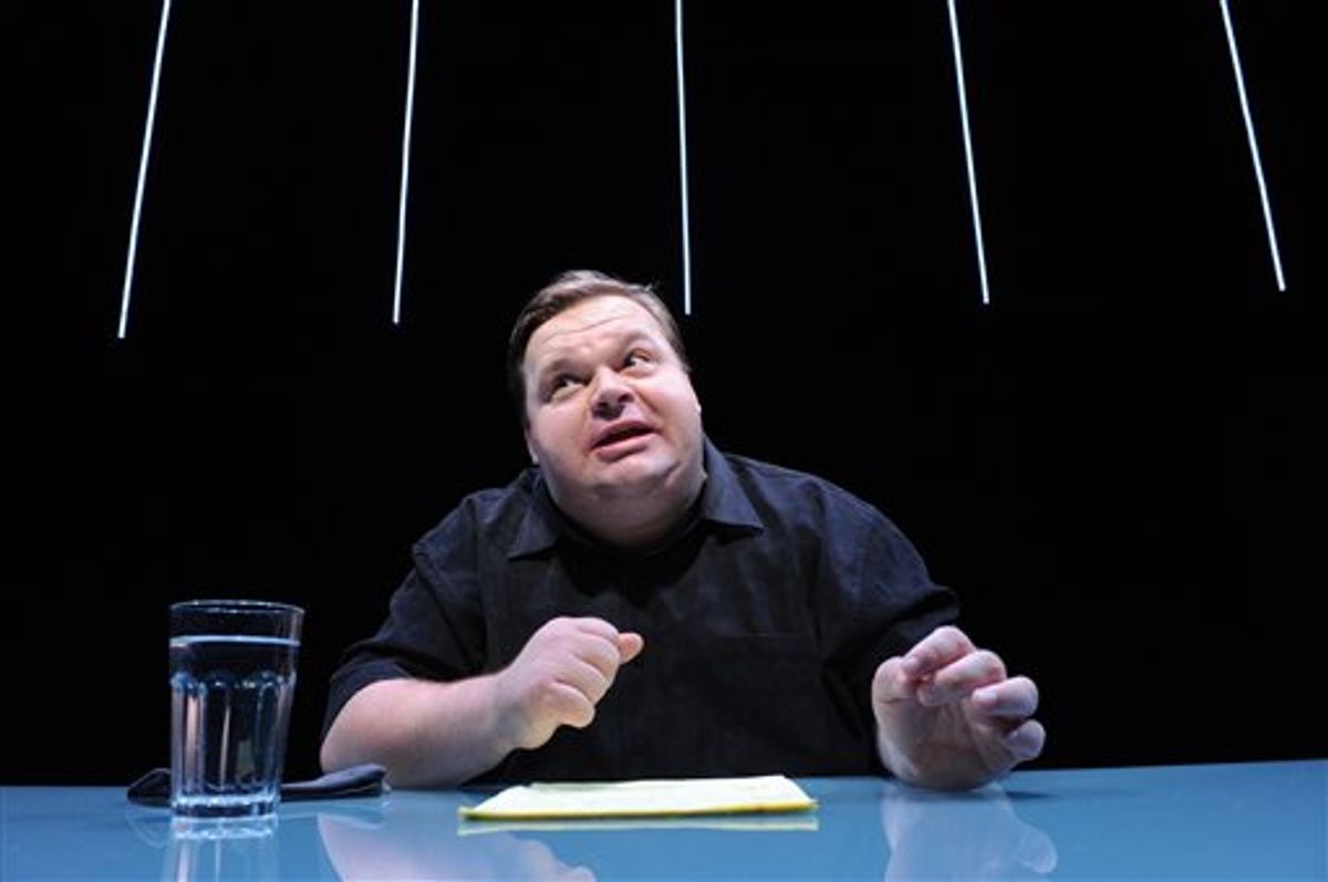 In this undated image released by The Public Theater, Mike Daisey is shown in a scene from "The Agony and The Ecstasy of Steve Jobs," in New York. Daisey, whose latest show has been being credited with sparking probes into how Apple's high-tech devices are made, is finding himself under fire for distorting the truth. The public radio show This American Life retracted a story Friday, March 16, 2012, that it broadcast in January about what Daisey said he saw while visiting a factory in China where iPads and iPhones are made. (AP Photo/The Public Theater, Stan Barouh)     (AP)