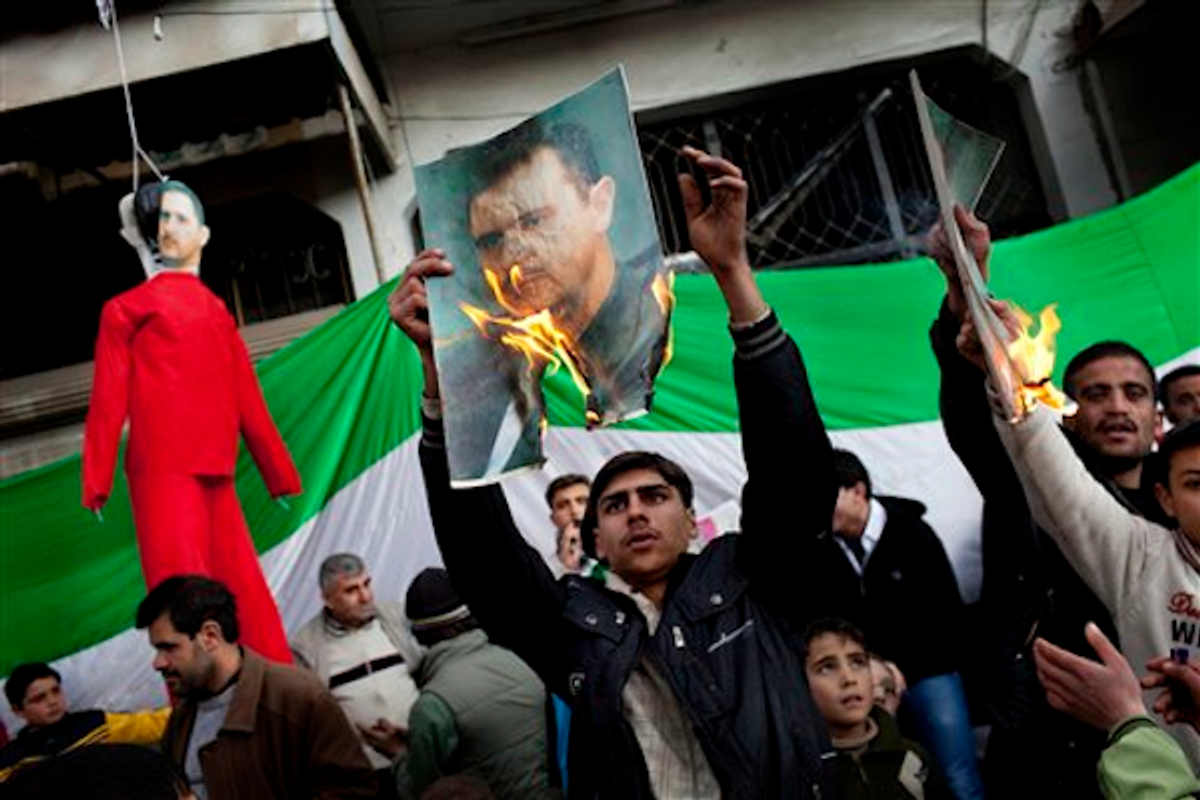 Protesters burn portraits of Syrian President Bashar al-Assad in northern Syria on Feb. 26, 2012           (AP Photo/Rodrigo Abd)