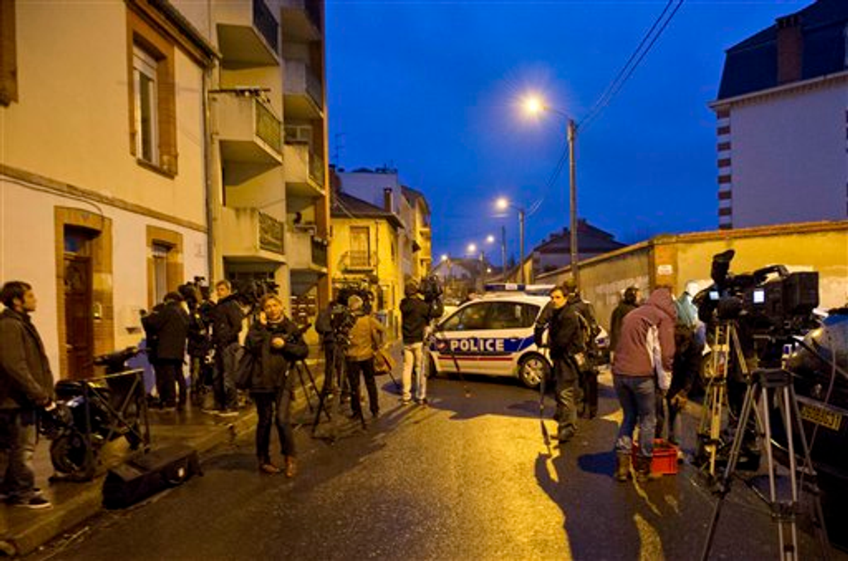  ournalists gather near by as French police secure the area where they exchanged fire and were negotiating with a gunman who claims connections to al-Qaida and is suspected of killing three Jewish schoolchildren, a rabbi and three paratroopers, Wednesday, March 21, 2012 in Toulouse, southwestern France   (AP Photo/Bruno Martin)
