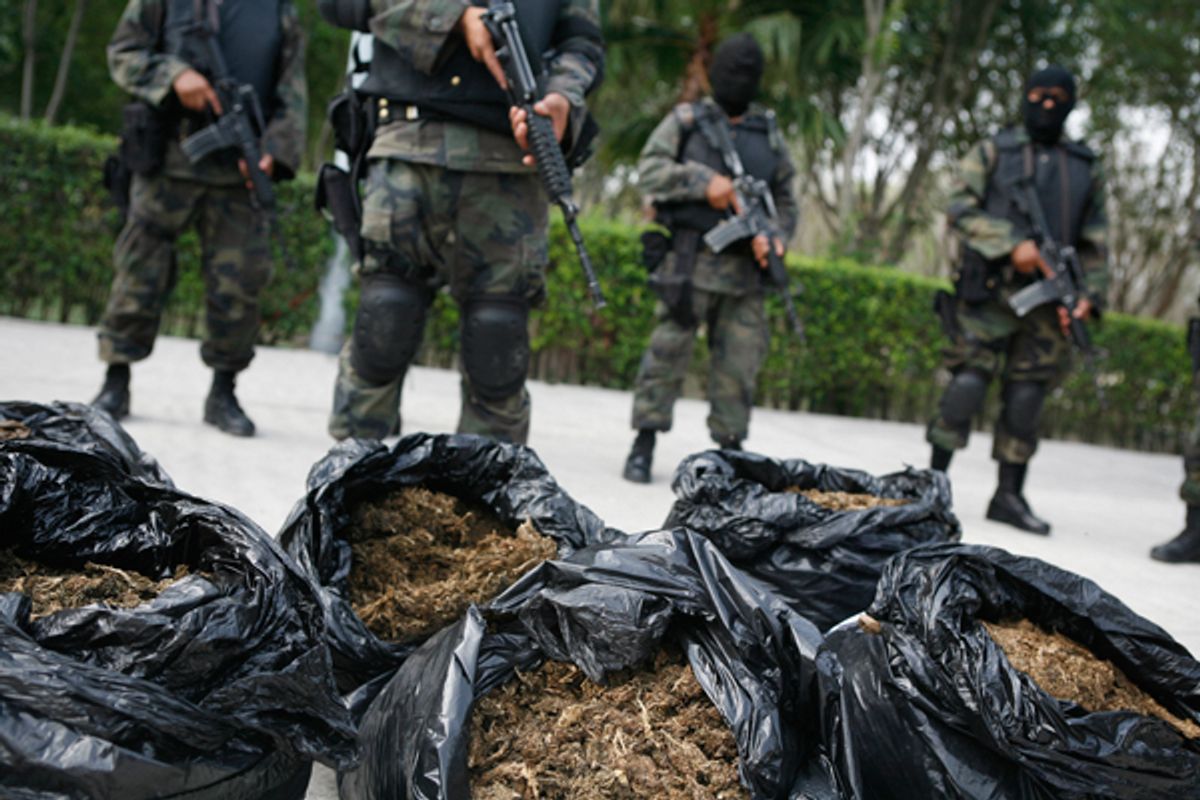 Soldiers stand guard next to bags of marijuana being displayed to the media at a military base on the outskirts of Monterrey, Mexico.        (Reuters/Tomas Bravo)