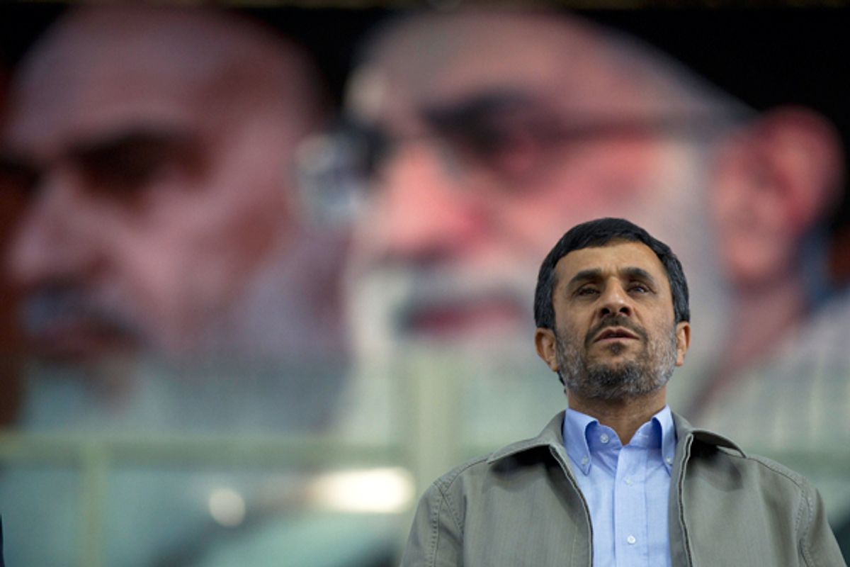 Iran's President Mahmoud Ahmadinejad stands beneath a portrait of Supreme Leader Ayatollah Ali Khamenei.        (Reuters/Caren Firouz)