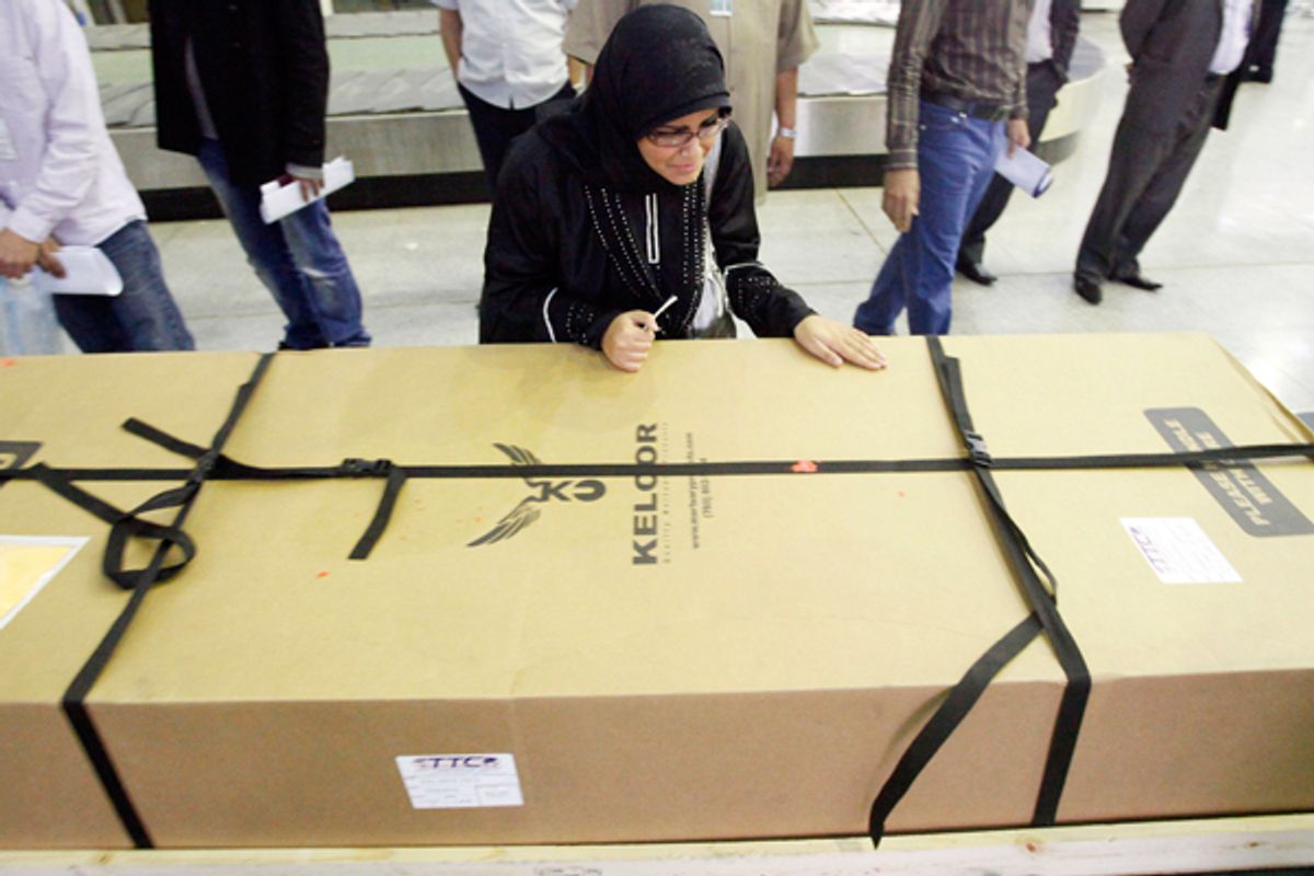 Fatima Alhimidi weeps over her mother Shaima Alawadi's coffin as it arrives in Najaf, Iraq.     (AP/Alaa al-Marjani)