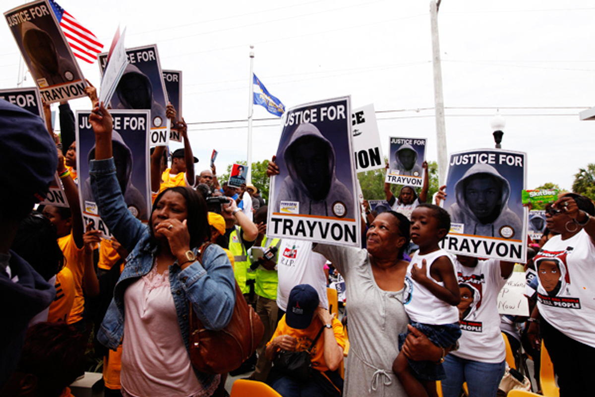 Demonstrators hold signs during a march to the front of the Sanford Police Department for Trayvon Martin in Sanford, Florida, March 31, 2012          (Reuters/Lucas Jackson)