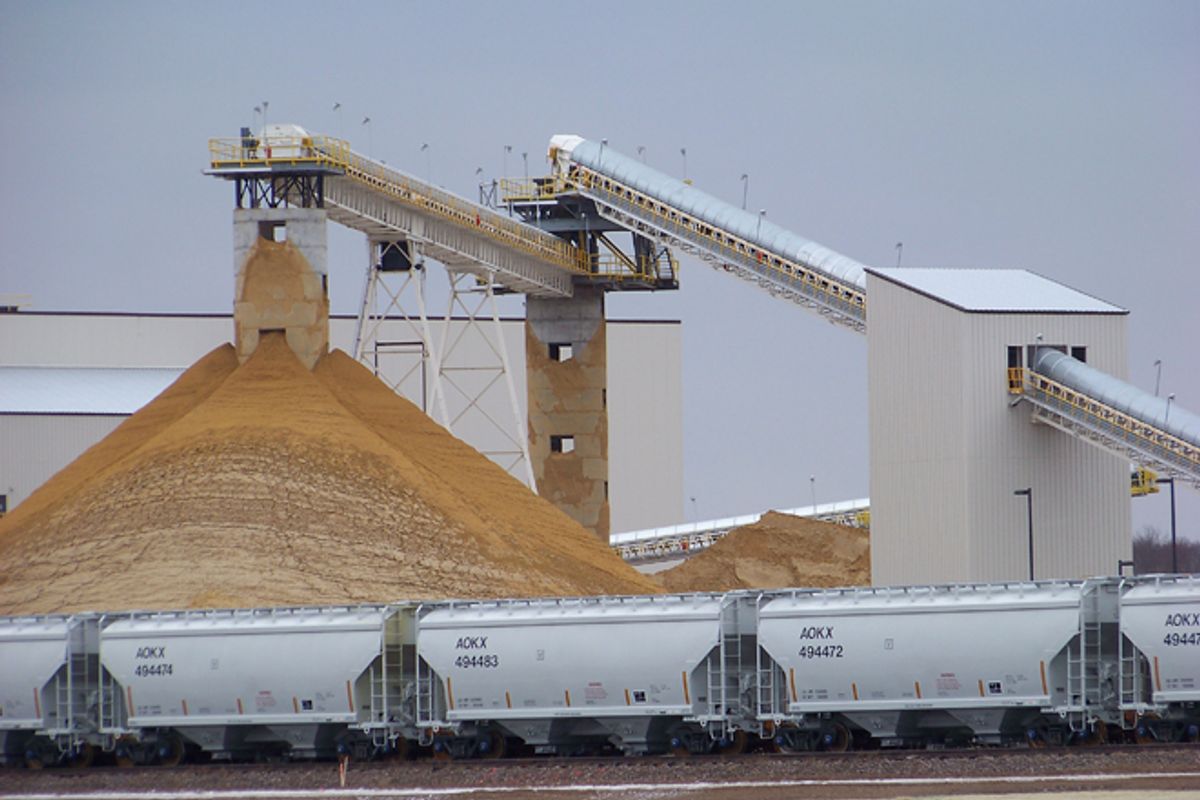 Frac sand piles up at a processing plant in Chippewa Falls, Wis.    (AP/Steve Karnowski)