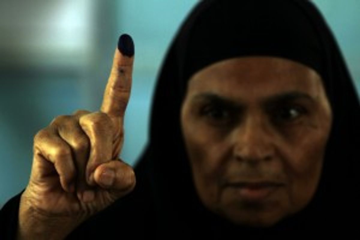 An Egyptian woman shows the ink on her finger after voting in an historic presidential election Wednesday, May 23, 2012, outside a polling station in Cairo, Egypt.      (AP Photo/Hasan Jamali)