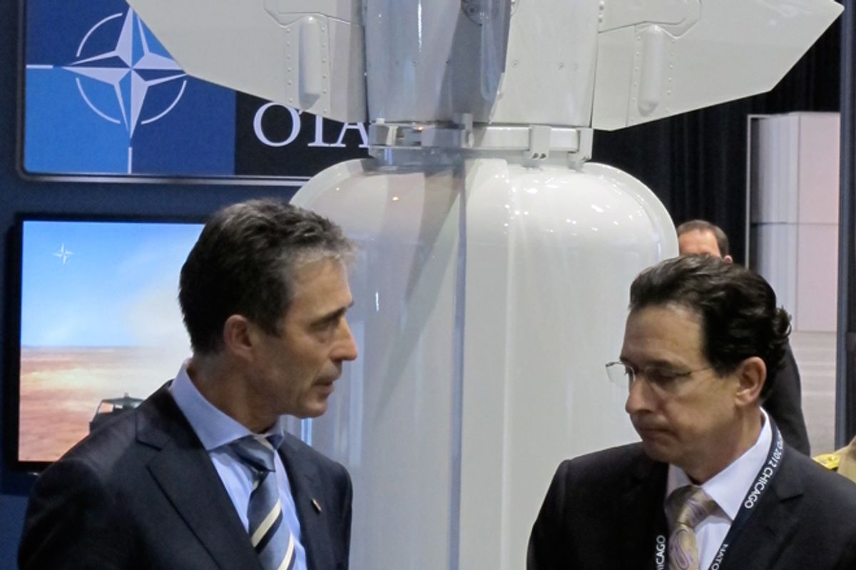 NATO Secretary General Anders Fogh Rasmussen speaks with a defense-industry official at the Chicago summit.  (Alexander Zaitchik)