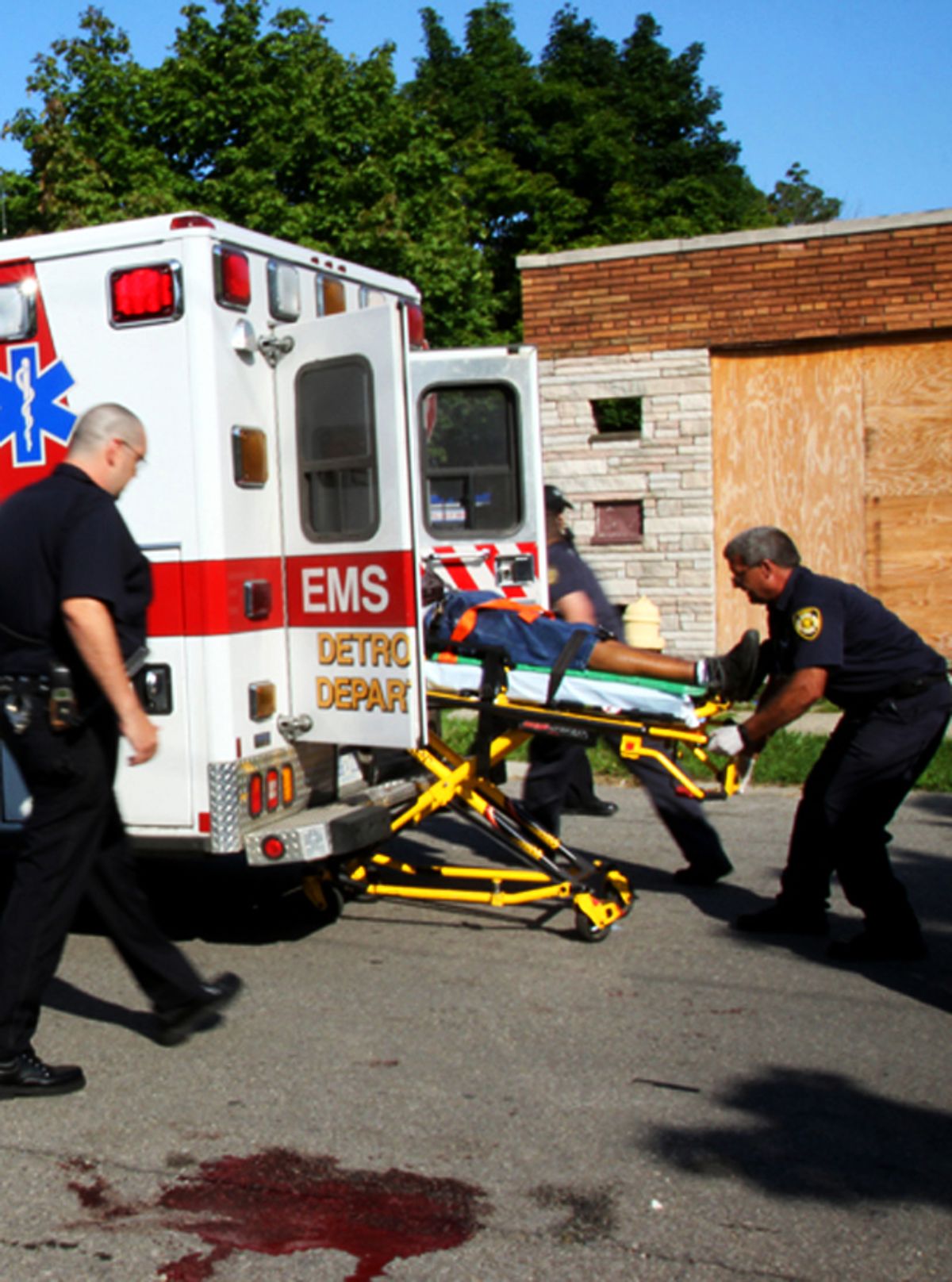Medics rush a fatally wounded shooting victim to the hospital at Morang and Somerset in Detroit.       (Amber Hunt)
