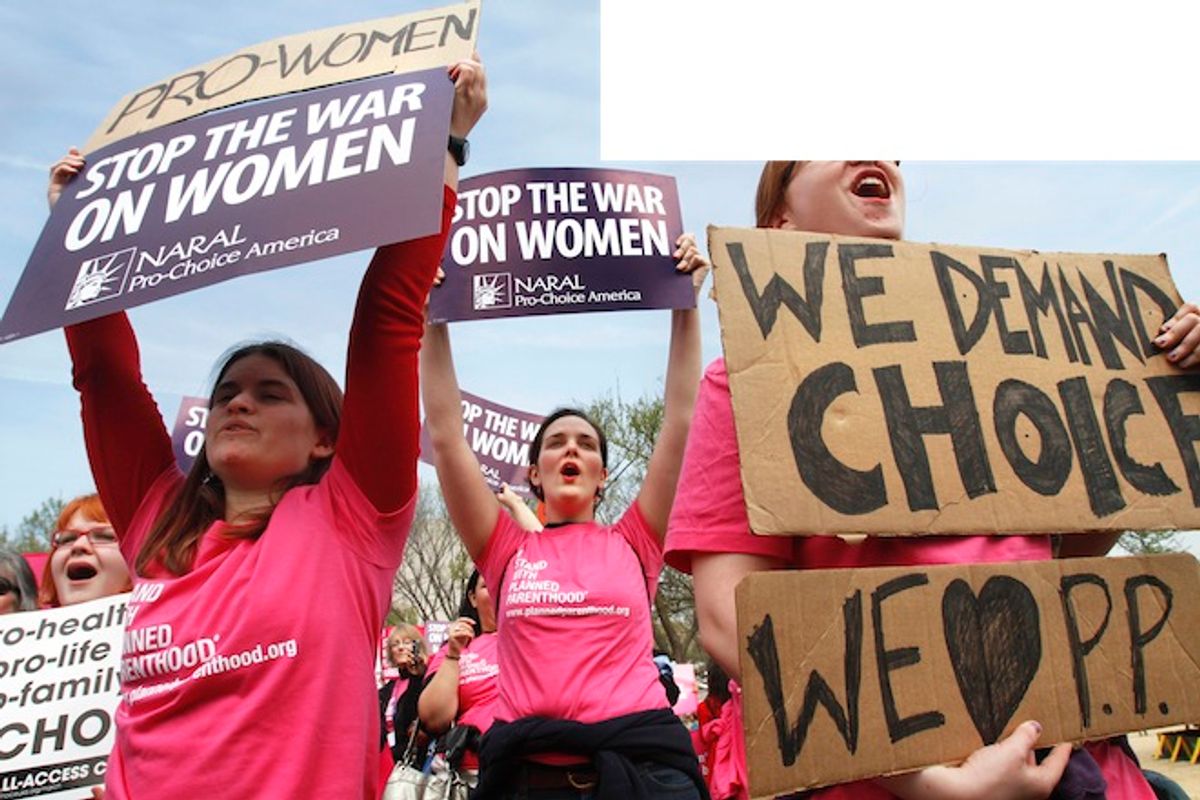 Erica Moses, 21, of Bethlehem, Pa., left, Rachel Graf Evans, 20, of Westtown Pa., and Hope Rehak, 21, of Chicago, take part in a rally in support of Planned Parenthood,  Thursday, April 7, 2011, on the National Mall in Washington.      (AP/Jacquelyn Martin)