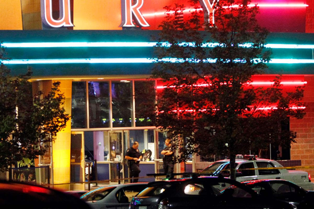 Police are pictured outside of a movie theatre where as many as 12 people were killed in Aurora, Colo. (AP Photo/Ed Andrieski)    (Ed Andrieski)