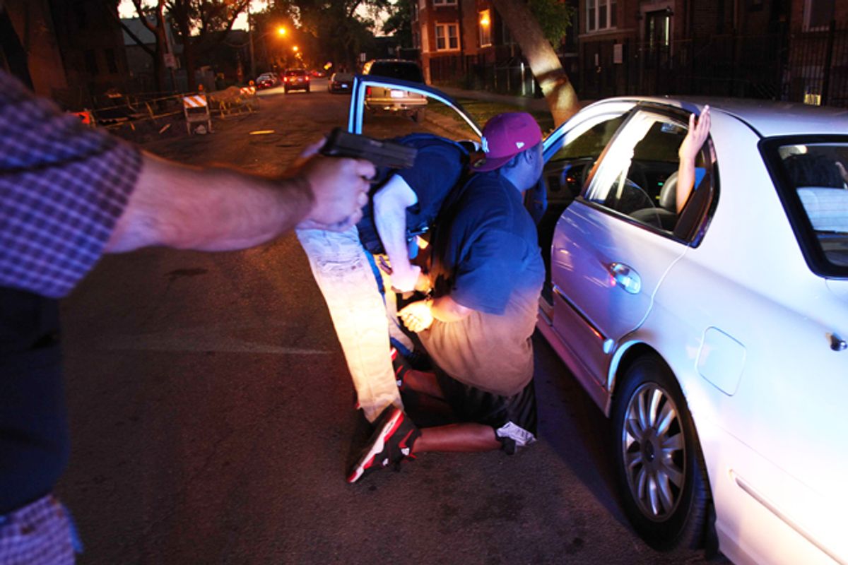 Chicago police arrest a gang member on an outstanding warrant on June 9.     (AP/Robert Ray)