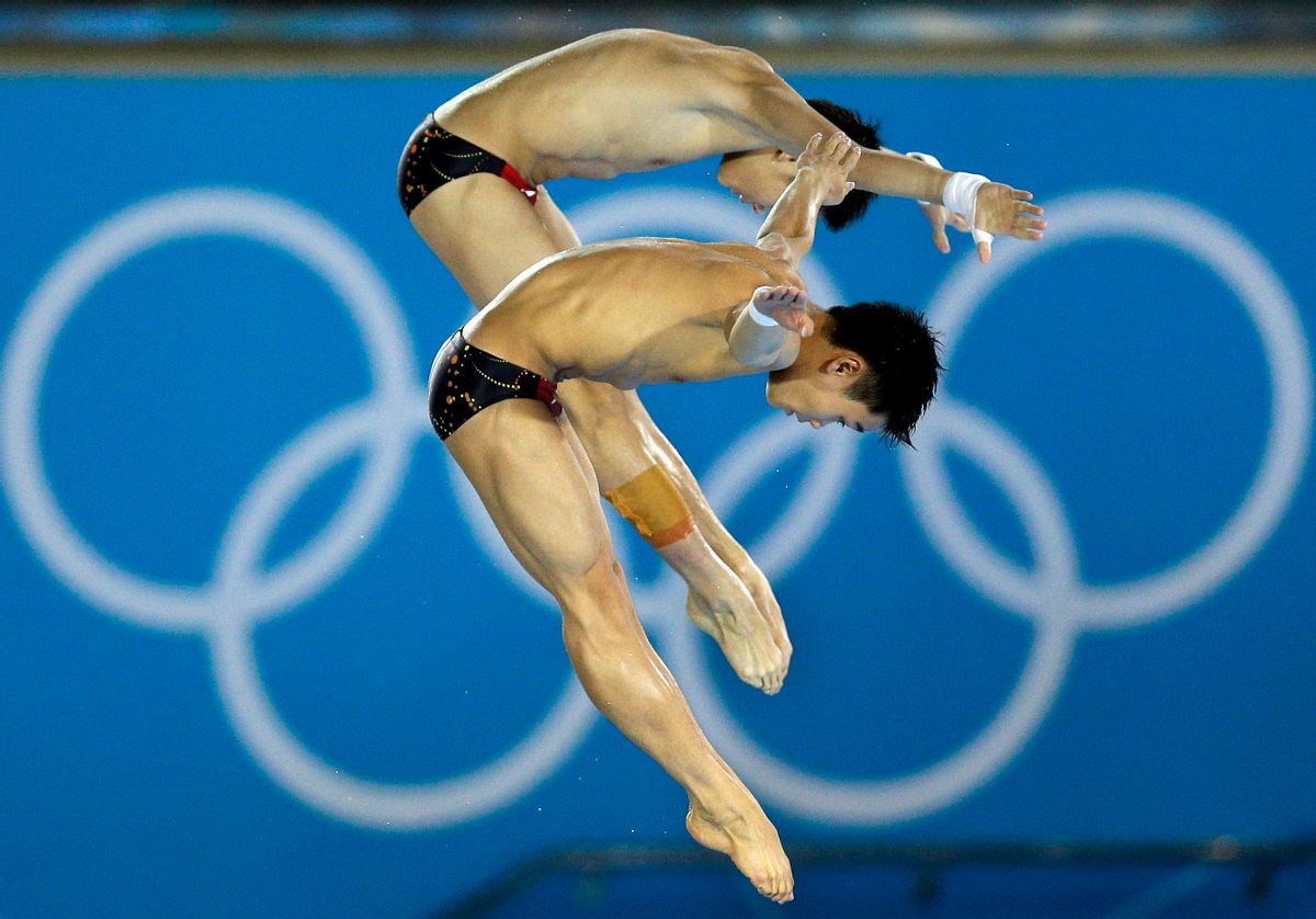 Gold medalists Cao Yuan and Yanquan Zhang from China compete during the Men's Synchronized 10 Meter Platform Diving final        (AP/Michael Sohn)