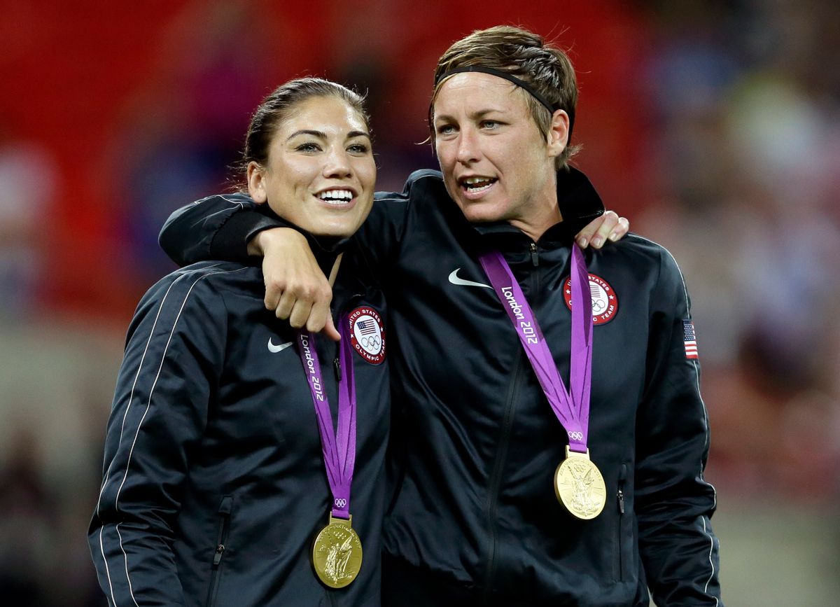 Abby Wambach, right, and teammate Hope Solo celebrate winning the gold medal during in the women's soccer final against Japan    (AP/Kirsty Wigglesworth)
