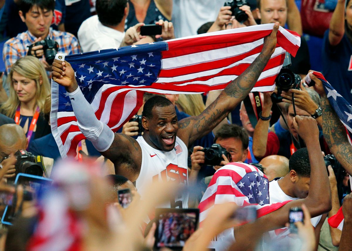 LeBron James of the U.S. celebrates with the flag after a victory against Spain in the men's gold medal basketball game     (Reuters/Brian Snyder)