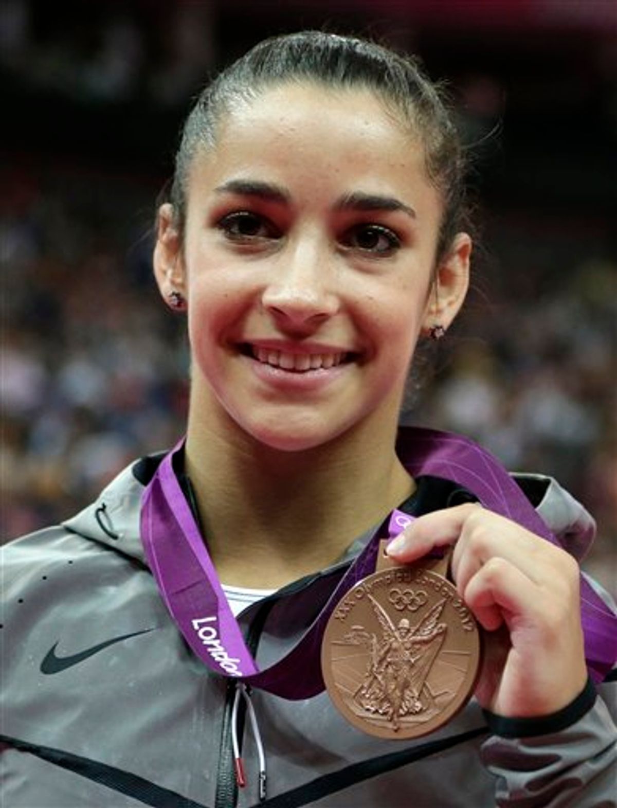 U.S. gymnast Alexandra Raisman displays her bronze medal for the balance beam during the artistic gymnastics women's apparatus finals at the 2012 Summer Olympics, Tuesday, Aug. 7, 2012, in London. (AP Photo/Gregory Bull)    (AP)