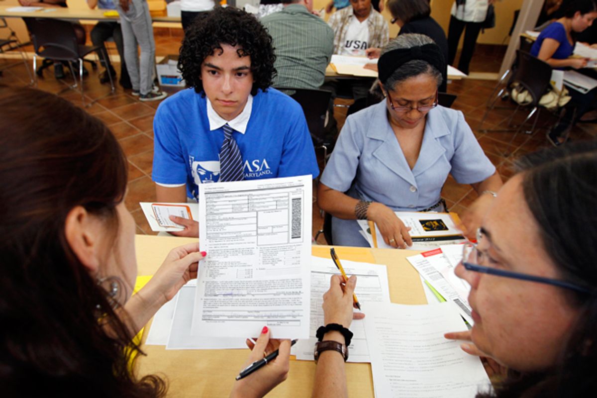 Colombian immigrants Daniel Nino, left, and his mother Patricia Cara get help filling Deferred Action Childhood Arrivals applications in Langley Park, Md.   (AP/Jose Luis Magana)
