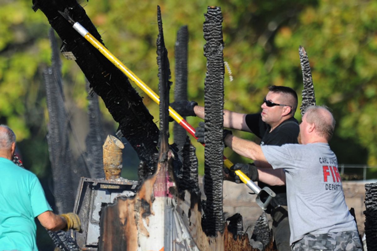 Firefighters maneuver debris following a fire at the Islamic Society of Joplin, Mo.      (AP/T. Rob Brown)