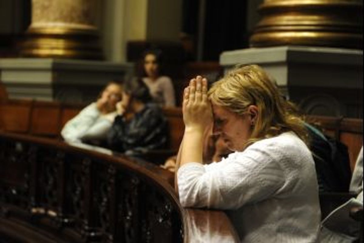 A Uruguayan woman prays at Uruguayan senate as lawmakers debate legalizing abortion.             (Miguel Rojo/AFP/Getty Images)
