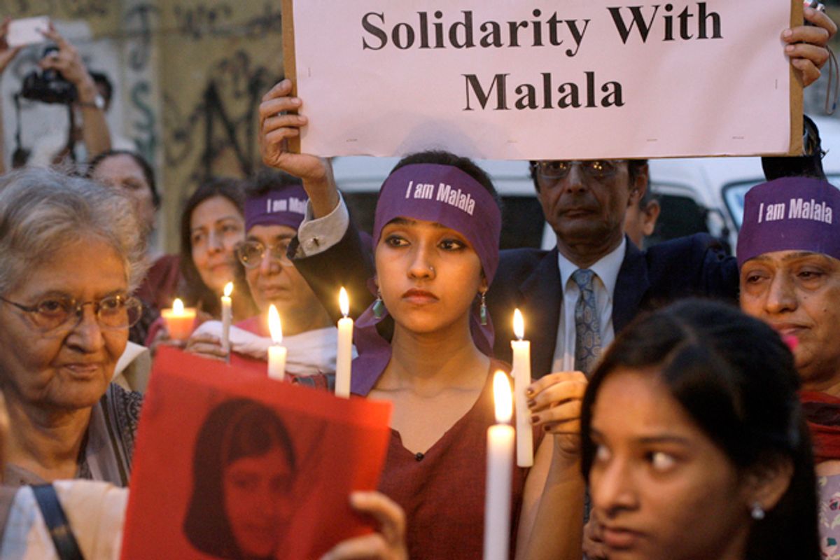 Pakistanis hold candles during a protest to condemn the attack on 14-year-old schoolgirl Malala Yousufzai, who was shot on Tuesday by the Taliban for speaking out in support of education for women, in Karachi, Pakistan, Oct. 11, 2012.   (AP/Shakil Adil)