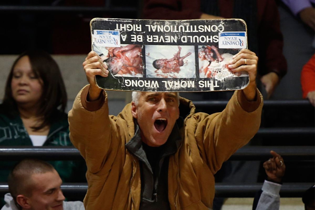 An anti-abortion protester at an Obama campaign event at the University of Cincinnati on Nov. 4.      (Reuters/Larry Downing)
