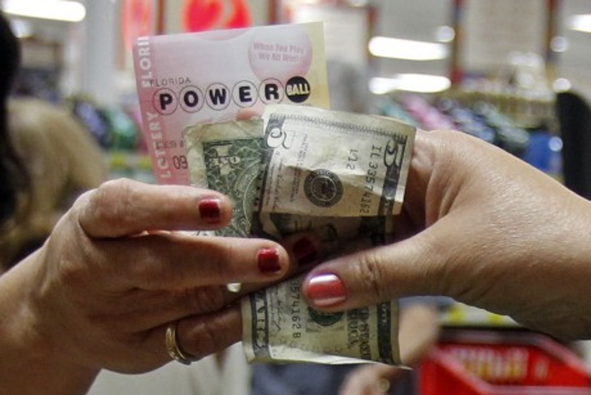  A customer buys three Powerball tickets at a local supermarket in Hialeah, Fla.,Tuesday (Credit: AP)   