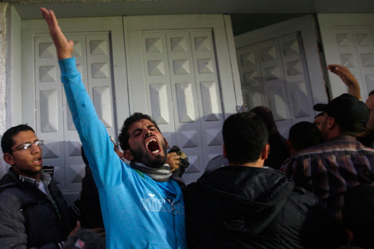 Palestinian men react at hospital after the body of Ahmed Jabari, head of the Hamas military wing, was brought,  in Gaza City, Wednesday, Nov. 14, 2012.         (AP/Hatem Moussa)
