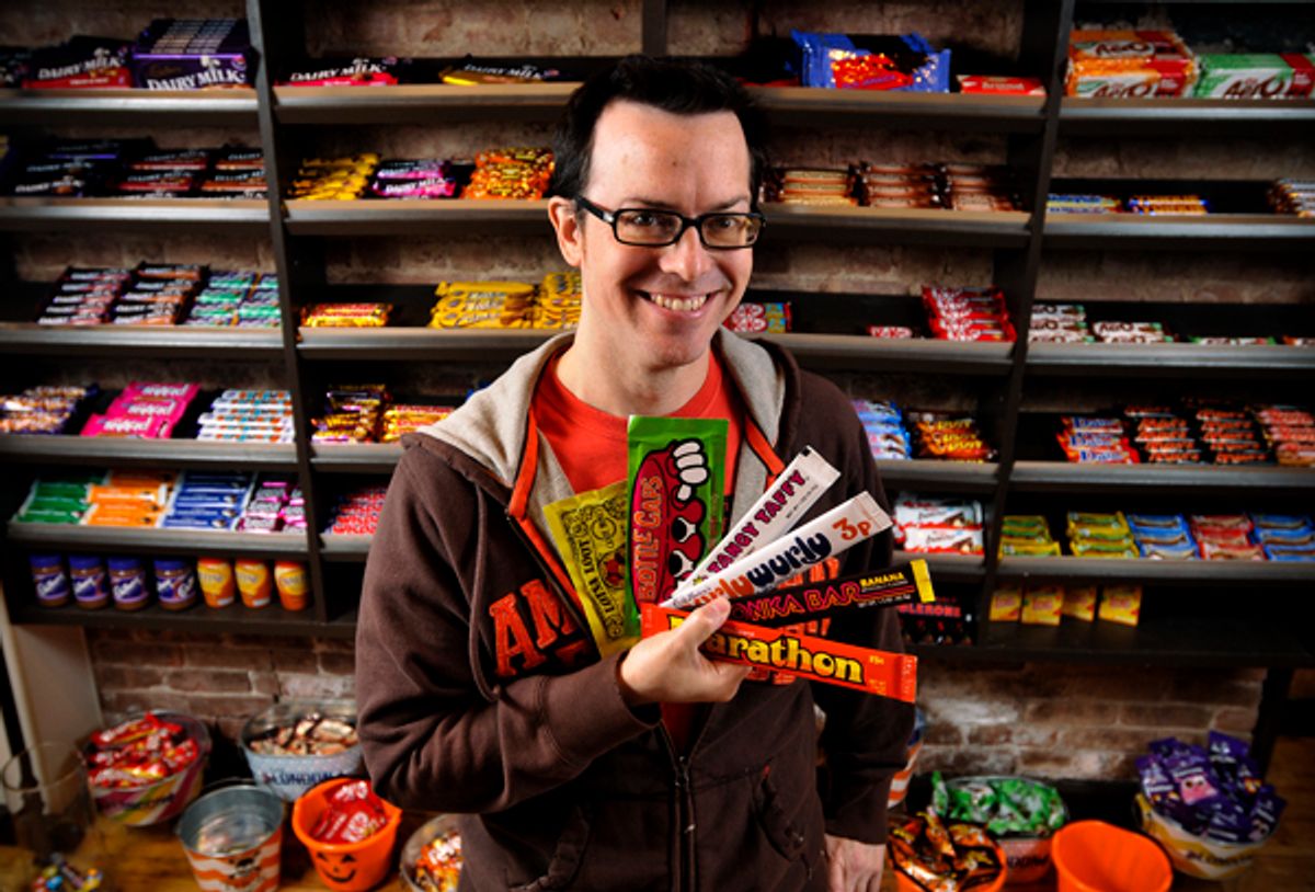 Jason Liebig holds a few pieces from his candy wrapper collection in the London Candy Company on the Upper East Side. Photos by Brad Horrigan.      