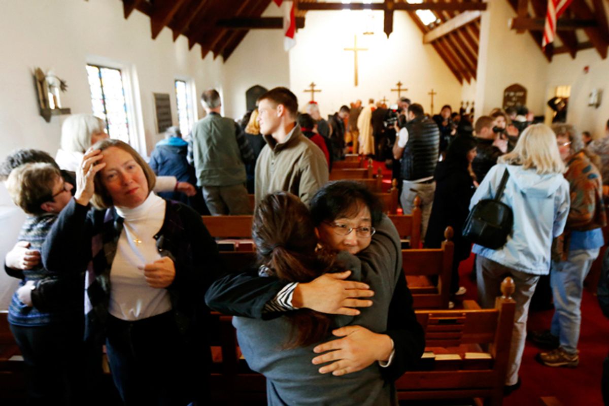 People embrace during a service at St. John's Episcopal Church, Saturday, Dec. 15, 2012.    (AP/Julio Cortez)