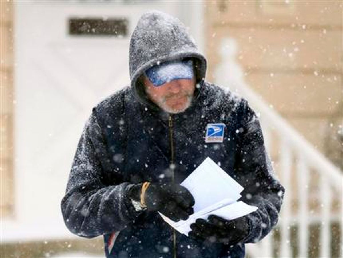 U. S. Post Office letter carrier Tim Bell delivers the mail during a snow storm in Havertown, Pa.    (AP Photo/Jacqueline Larma)