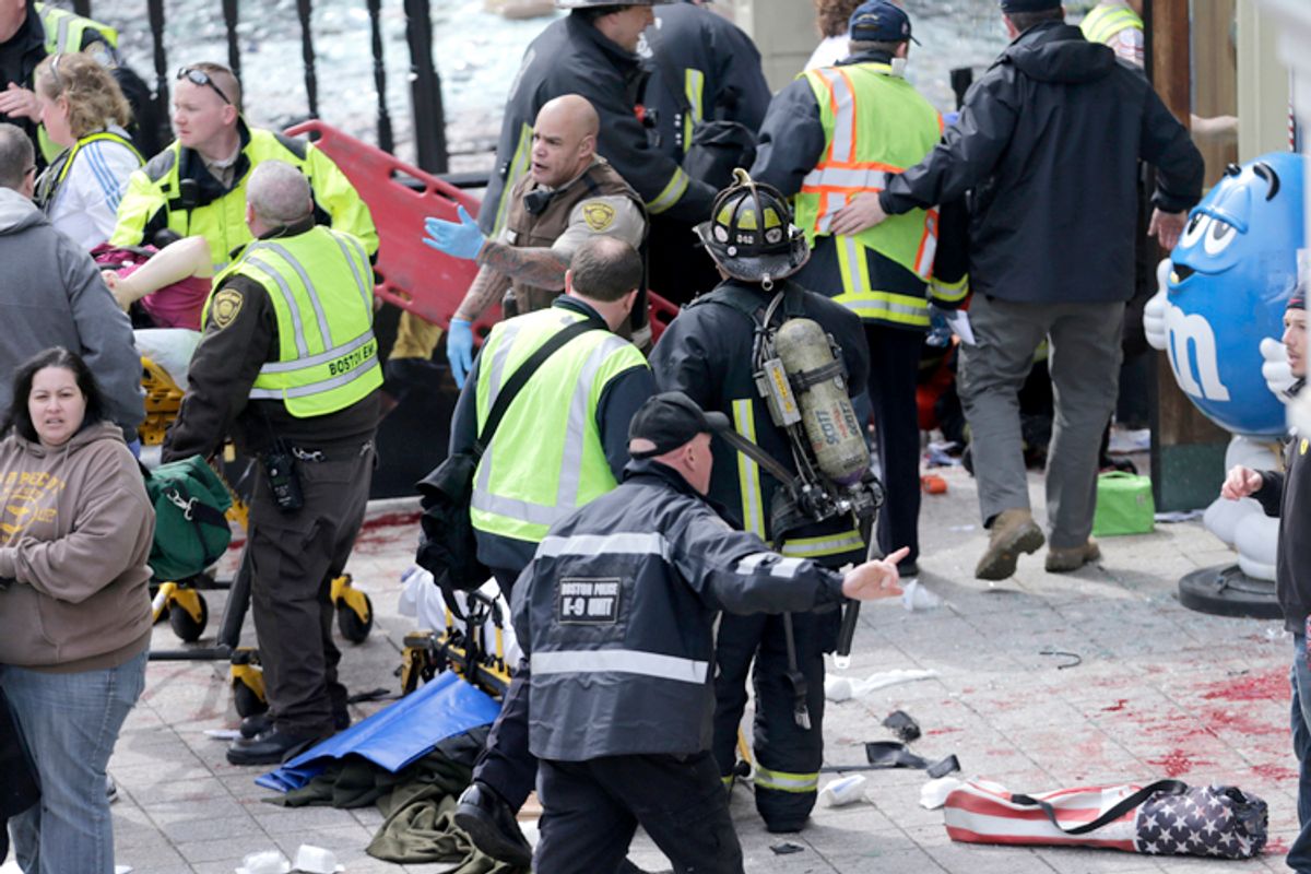Medical workers aid injured people at the finish line of the 2013 Boston Marathon following an explosion in Boston, Monday, April 15, 2013.     (AP/Charles Krupa)