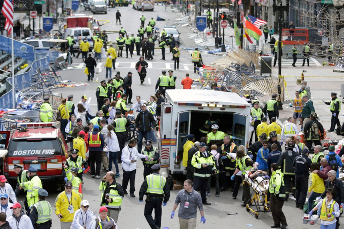 Medical workers aid injured people at the finish line of the 2013 Boston Marathon following an explosion in Boston, Monday, April 15, 2013.  (AP/Charles Krupa)