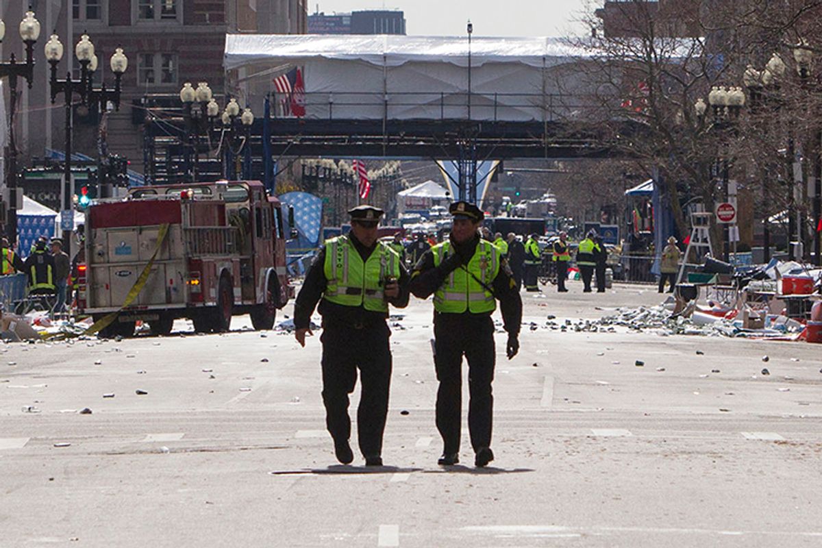 Boston police officers patrol down Boylston Street near the scene of multiple explosions near the end of the Boston Marathon finish line in Boston, Massachusetts April 15, 2013.      (Reuters/Scott Eisen)
