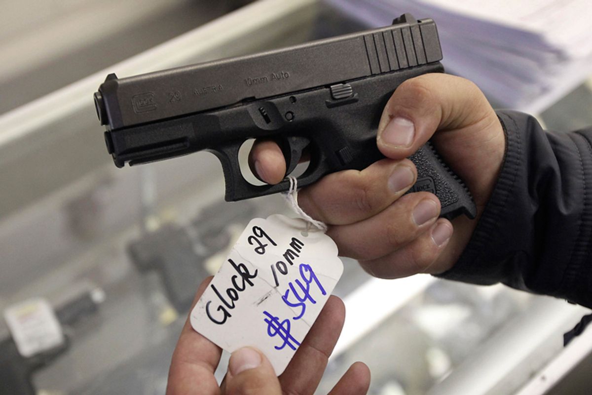 A customer looks over a Glock 29 10mm hand gun at the Guns-R-Us gun shop in Phoenix, Arizona, December 20, 2012.    (Reuters/Ralph Freso)