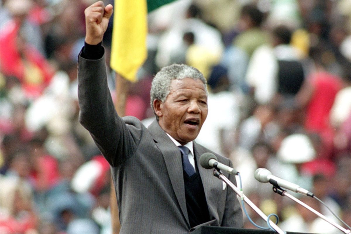 Nelson Mandela gives the black power salute to 120,000 supporters packing Soweto's Soccer City stadium, near Johannesburg, shortly after his release from 27 years in prison.  (AP/Weitz)      