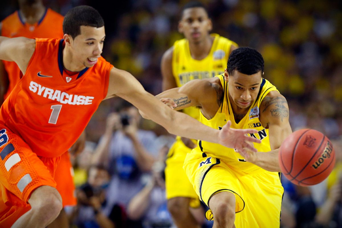 Syracuse's Michael Carter-Williams and Michigan's Trey Burke lunge for the ball during their Final Four game on April 6.  (Reuters/Chris Keane)