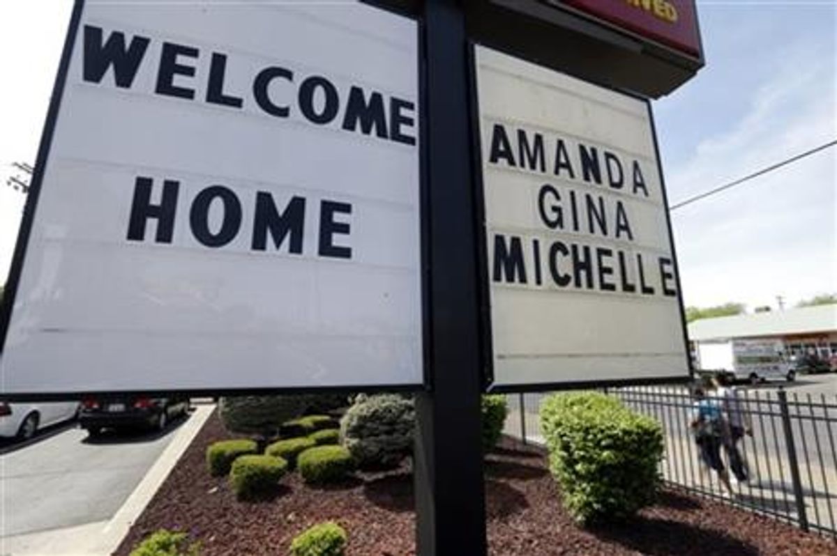 A welcome home sign is posted at a restaurant near a crime scene where three women were held captive for a decade in Cleveland, Ohio. (AP Photo/David Duprey)