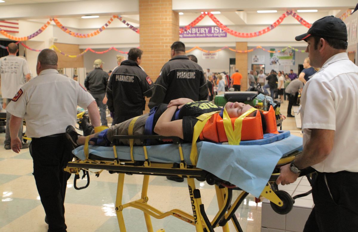 An unidentified injured person is carried to an ambulance in Granbury, Texas, on Wednesday May 15, 2013.      (AP/Mike Fuentes)