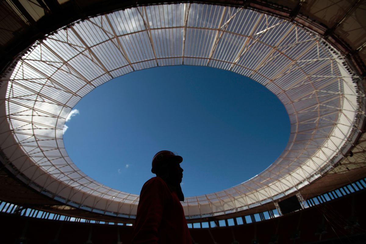 An employee stand inside the National Stadium Mane Garrincha in Brasilia, Brazil, Tuesday, May 14, 2013.   (AP/Eraldo Peres)