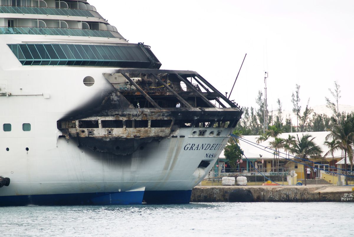 The fire-damaged exterior of Royal Caribbean's Grandeur of the Seas cruise ship is seen while docked in Freeport, Grand Bahama island, Monday, May 27, 2013.   (AP/The Freeport News, Jenneva Russell)