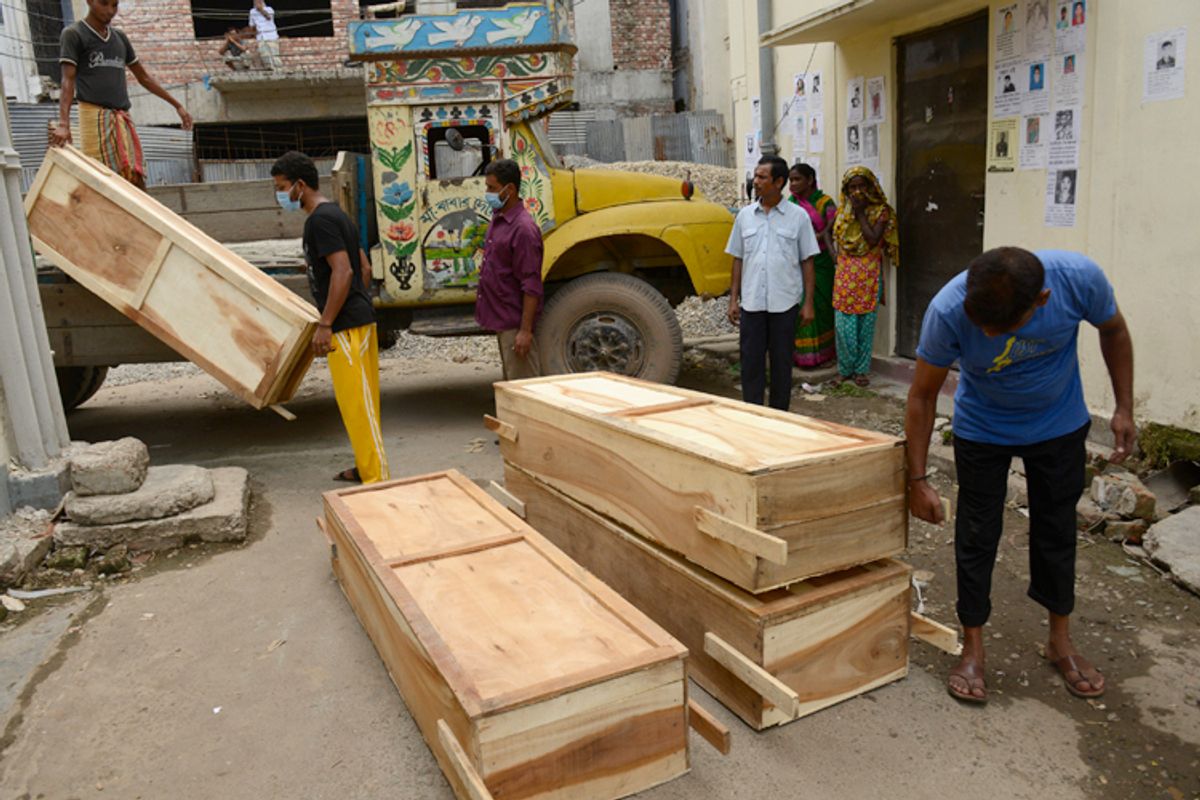 Workers off-load coffins at a morgue on Wednesday May 1, 2013 in Dhaka, Bangladesh.   (AP/Ismail Ferdous)